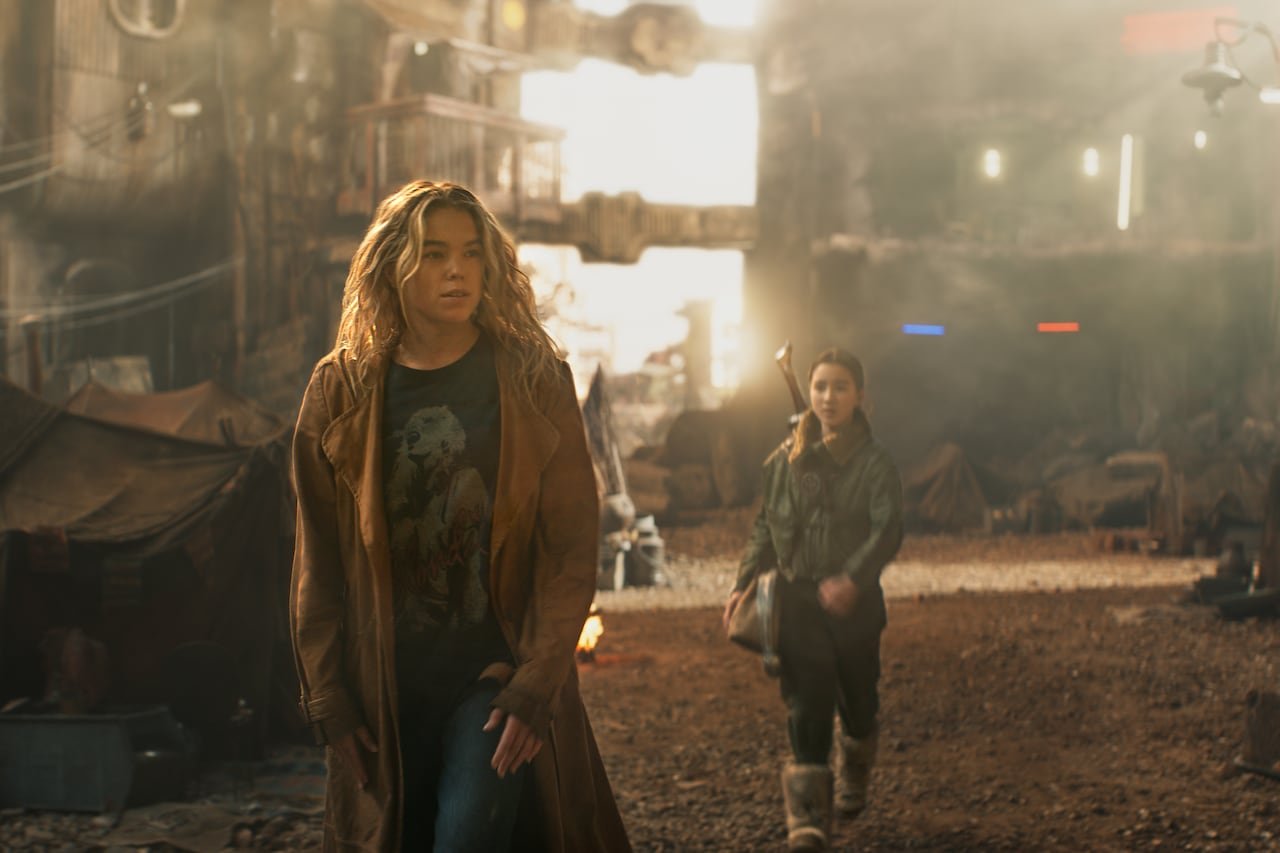 default-46 A woman and girl walk down a dirty, alien-looking street.